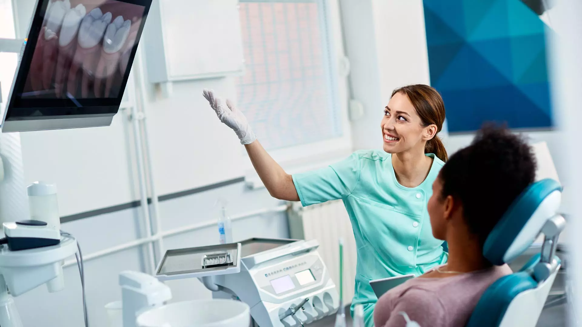 Dentist reviewing a panoramic X-ray with a patient